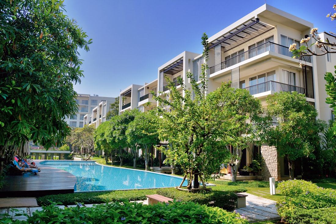 Área comum de um condomínio residencial com piscina e jardim
